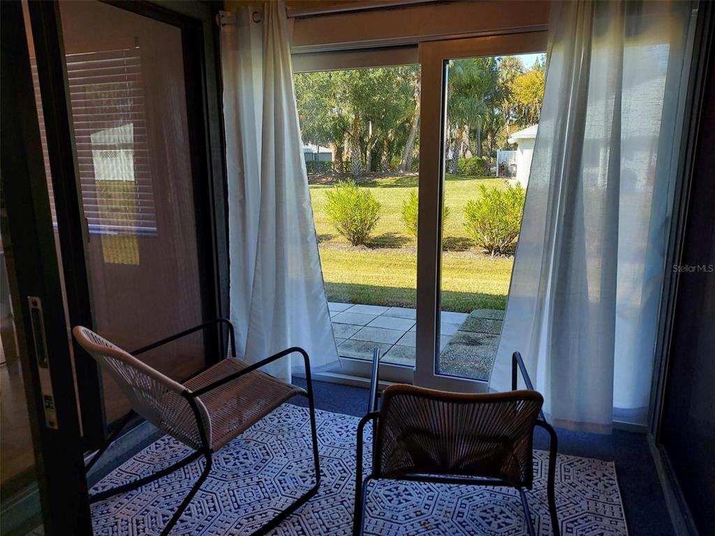 47 Lake Forest Place, Unit 47 Palm Coast, FL 32137 - Photo 12 of 12 a living room with a table and a window