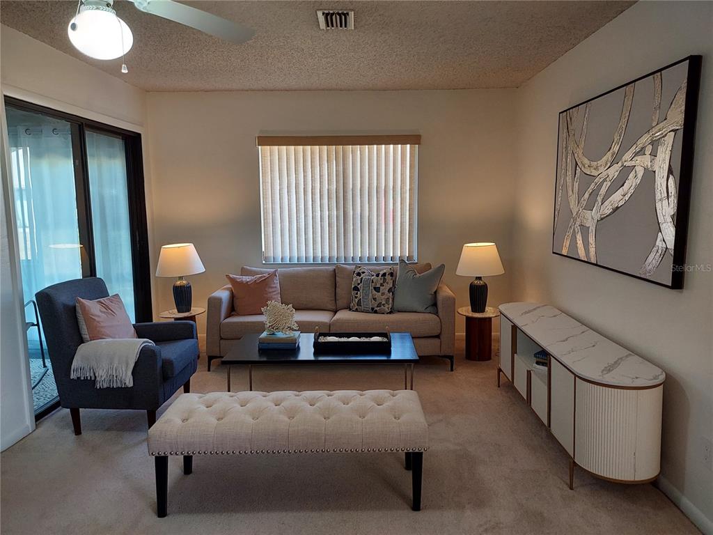 47 Lake Forest Place, Unit 47 Palm Coast, FL 32137 - Photo 3 of 12 a living room with furniture and a window
