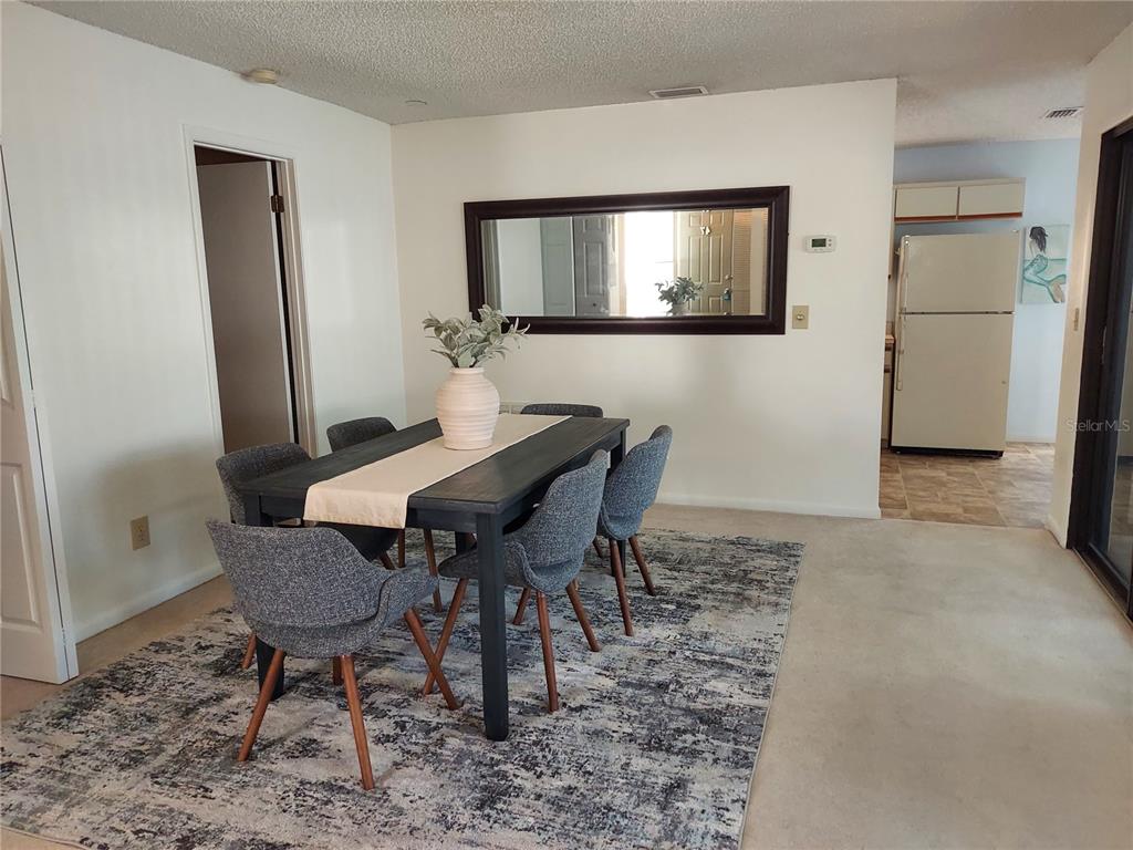 47 Lake Forest Place, Unit 47 Palm Coast, FL 32137 - Photo 4 of 12 a view of a livingroom with furniture and a mirror