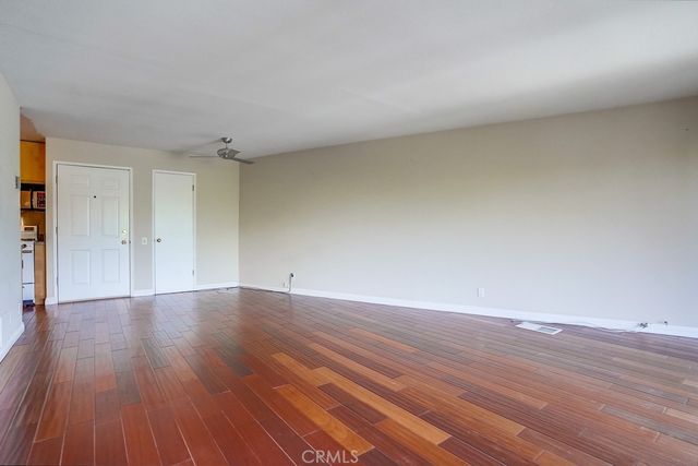 a view of an empty room and wooden floor
