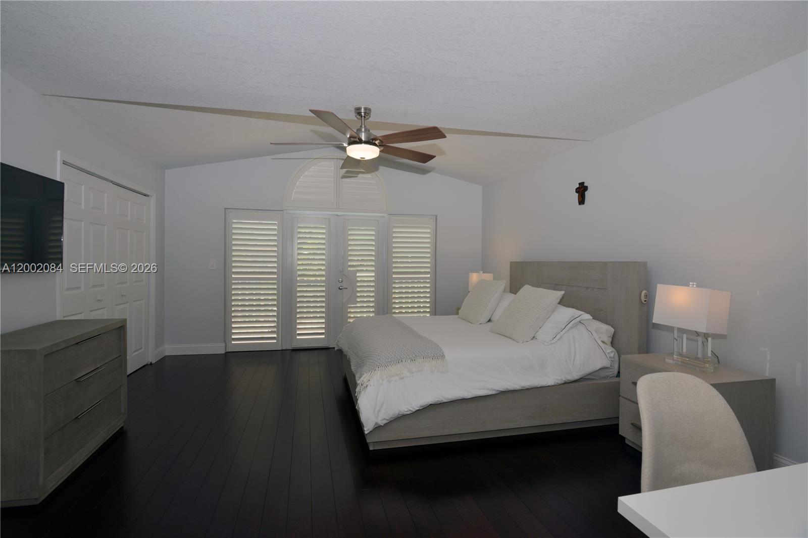 3081 Matilda Street, Unit A Miami, FL 33133 - Photo 12 of 14 a bedroom with a bed a window and a flat screen tv