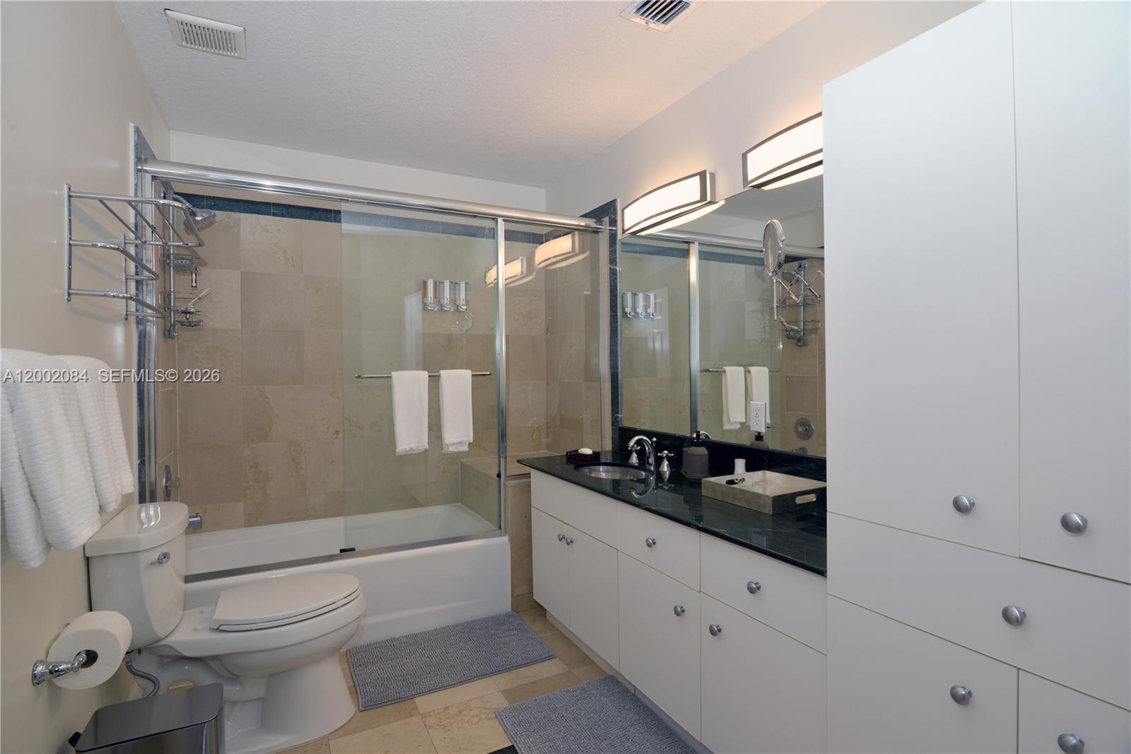 3081 Matilda Street, Unit A Miami, FL 33133 - Photo 13 of 14 a bathroom with a granite countertop sink toilet and shower