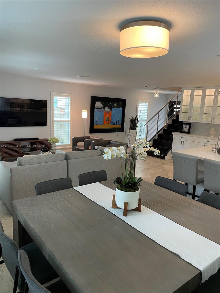 3081 Matilda Street, Unit A Miami, FL 33133 - Photo 8 of 14 a living room with furniture and a flat screen tv