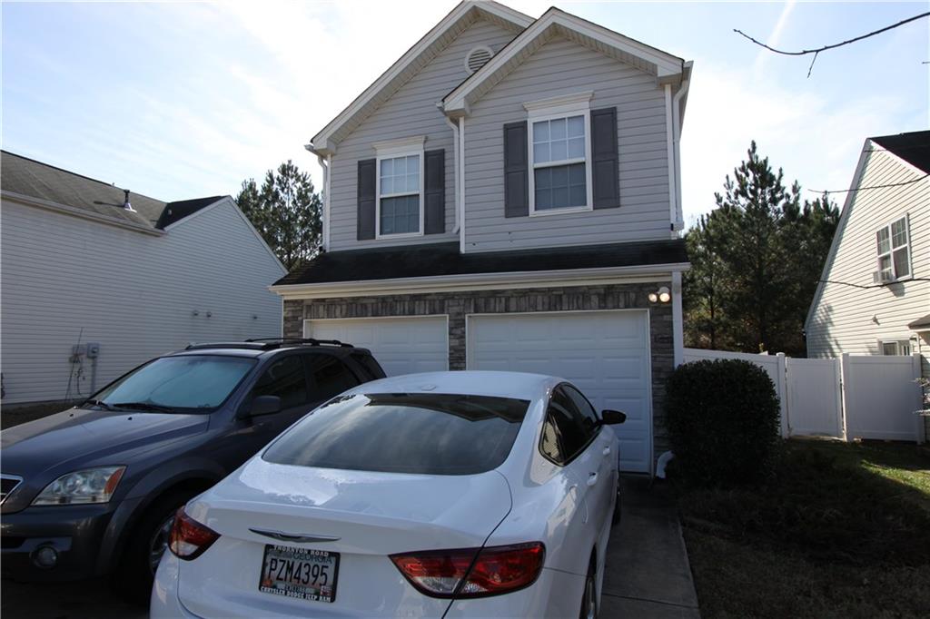 a couple of cars parked in front of a house