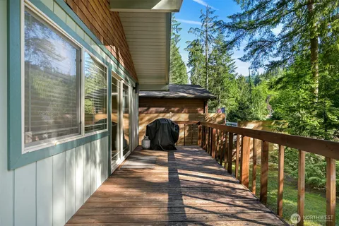 a view of a porch with wooden floor and gate