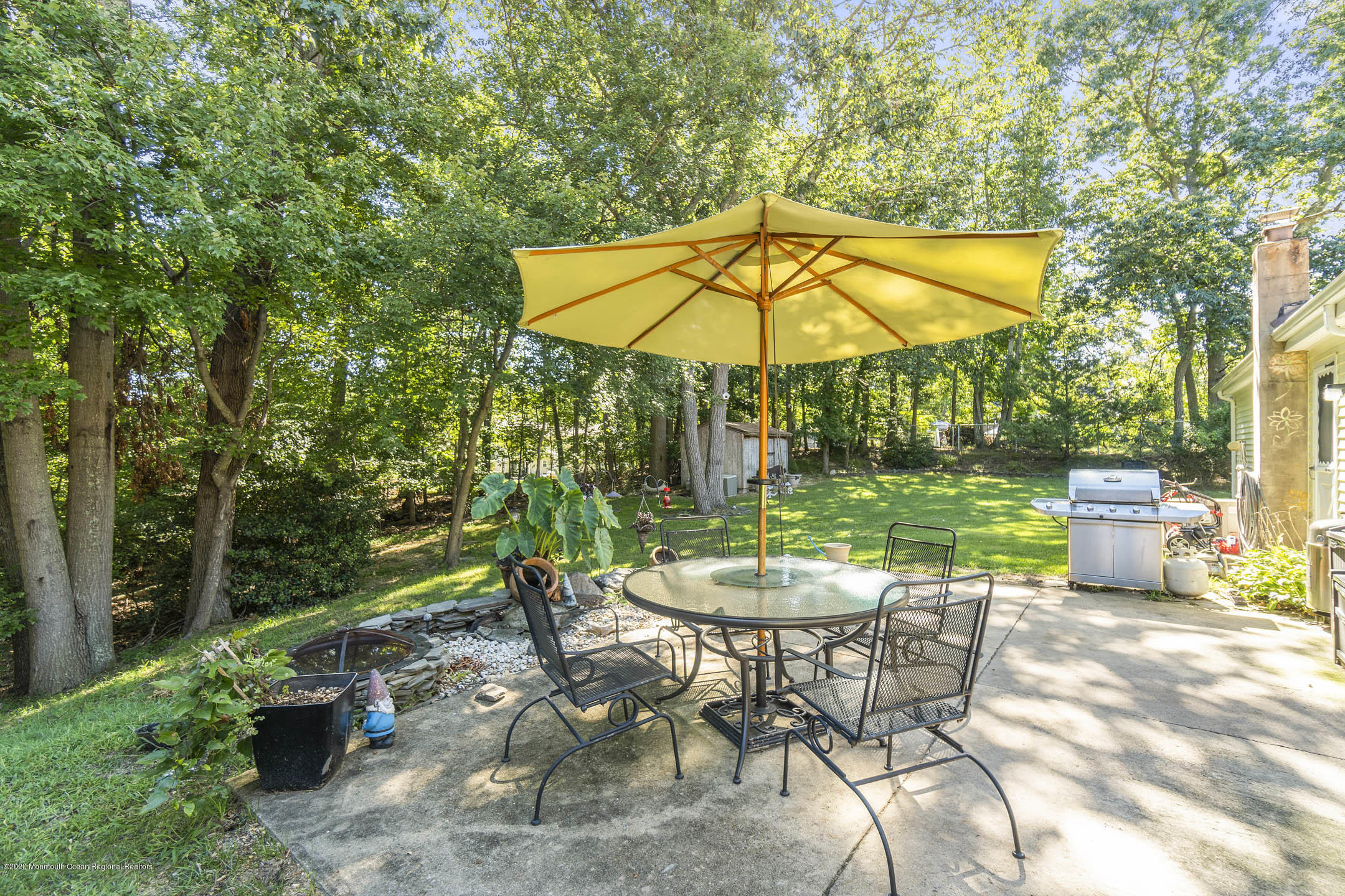 4 Oxford Road Jackson, NJ 08527 - Photo 22 of 29 a view of a backyard with table and chairs under an umbrella