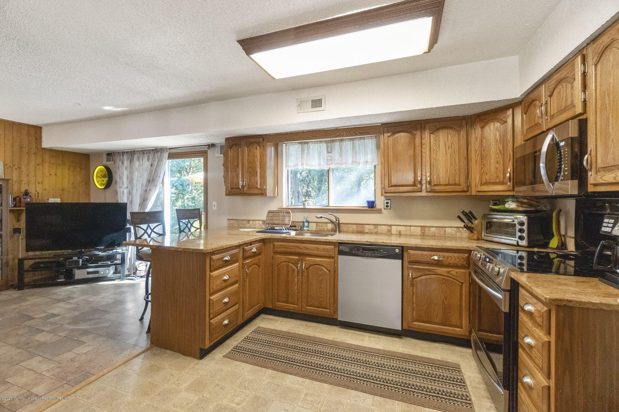 4 Oxford Road Jackson, NJ 08527 - Photo 8 of 29 a kitchen with stainless steel appliances granite countertop a stove a sink dishwasher and a microwave oven with white cabinets