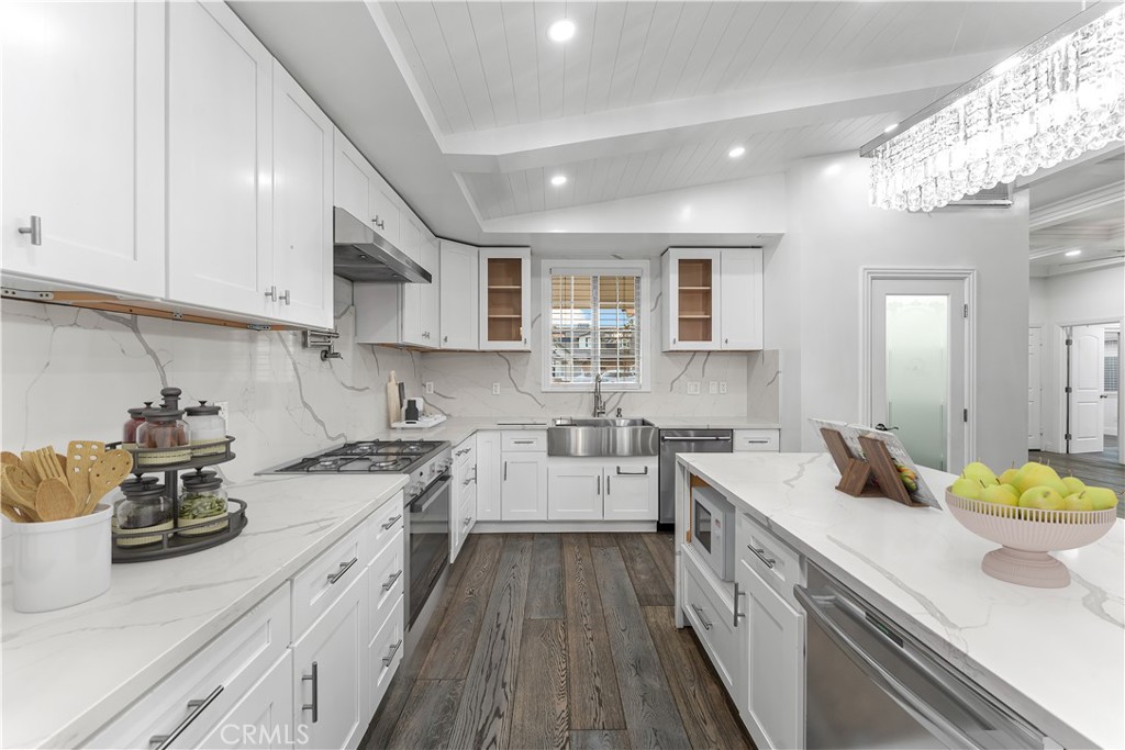 6418 Ringsdale Court Bakersfield, CA 93313 - Photo 12 of 59 a kitchen with a sink stove and cabinets