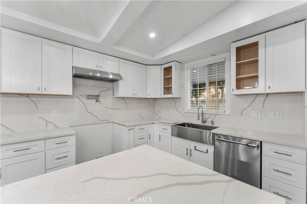 6418 Ringsdale Court Bakersfield, CA 93313 - Photo 18 of 59 a kitchen with a sink stove and cabinets