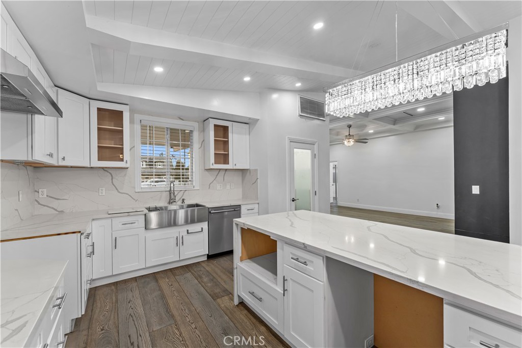 6418 Ringsdale Court Bakersfield, CA 93313 - Photo 19 of 59 a kitchen with a sink stove and cabinets