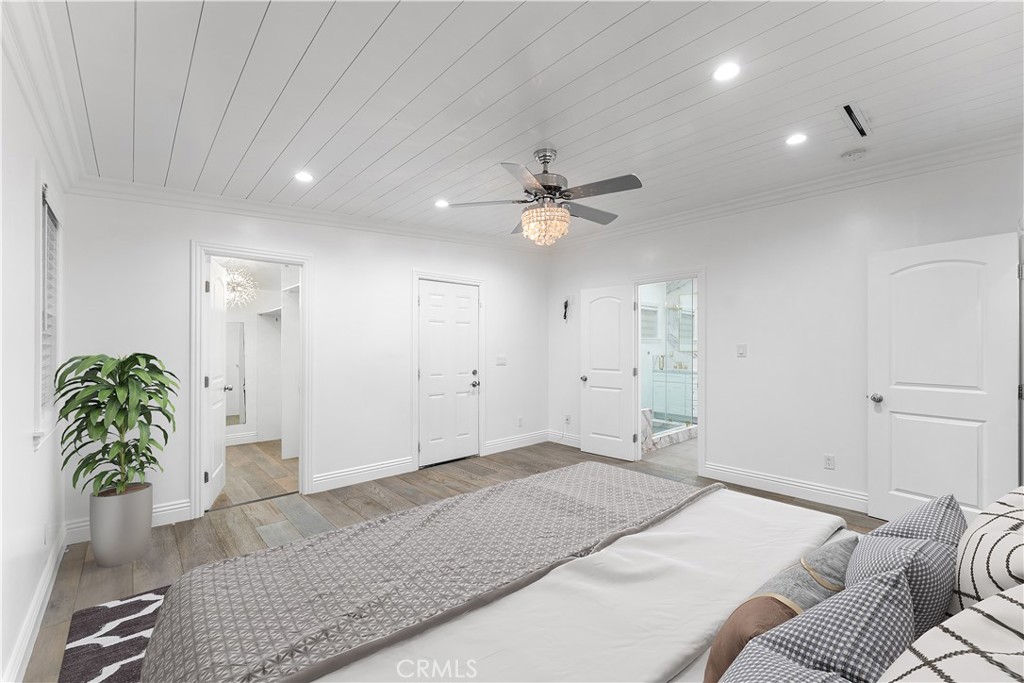 6418 Ringsdale Court Bakersfield, CA 93313 - Photo 25 of 59 a bedroom with a bed and a chandelier