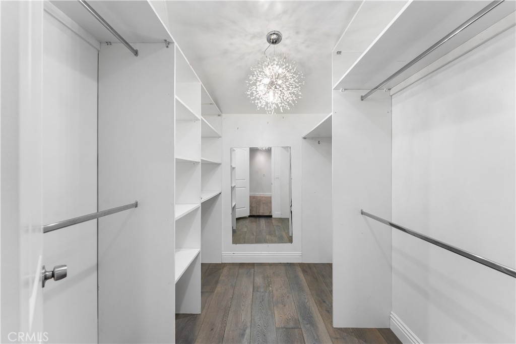 6418 Ringsdale Court Bakersfield, CA 93313 - Photo 28 of 59 a view of a hallway with a chandelier fan and wooden floor
