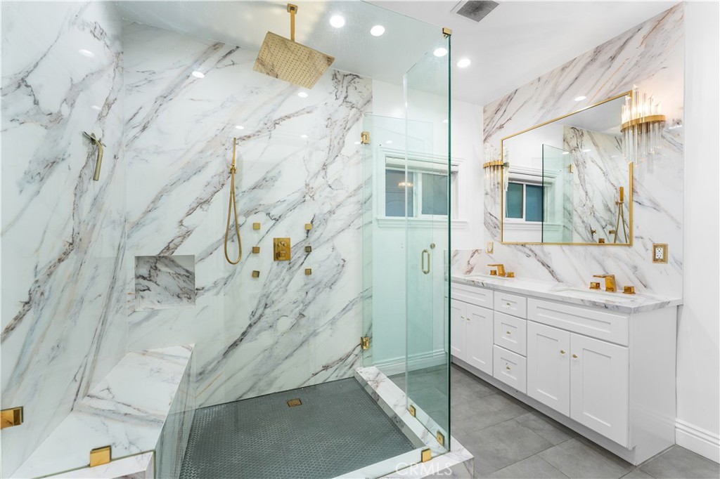6418 Ringsdale Court Bakersfield, CA 93313 - Photo 30 of 59 a bathroom with a sink and mirror
