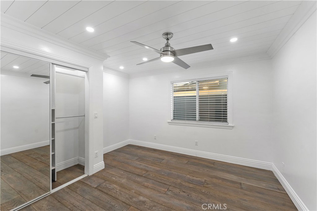 6418 Ringsdale Court Bakersfield, CA 93313 - Photo 37 of 59 a view of an empty room with wooden floor and a window