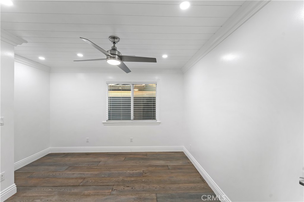6418 Ringsdale Court Bakersfield, CA 93313 - Photo 38 of 59 an empty room with wooden floor ceiling fan and window