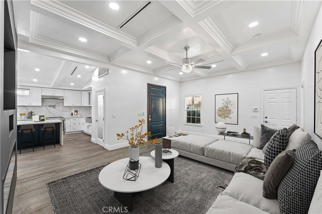 6418 Ringsdale Court Bakersfield, CA 93313 - Photo 4 of 59 a living room with furniture and a dining table with wooden floor
