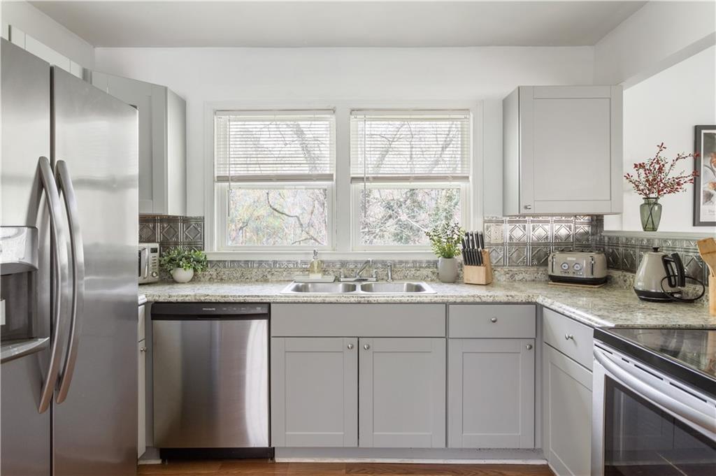 2175 Glendale Drive Decatur, GA 30032 - Photo 10 of 21 a kitchen with stainless steel appliances granite countertop a sink a stove and a refrigerator