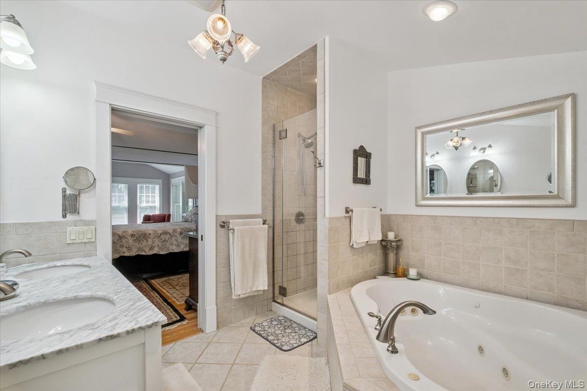 342 Lake Shore Road Putnam Valley, NY 10579 - Photo 27 of 46 Full bathroom featuring tile patterned floors, a stall shower, a jetted tub, ensuite bathroom, and double vanity