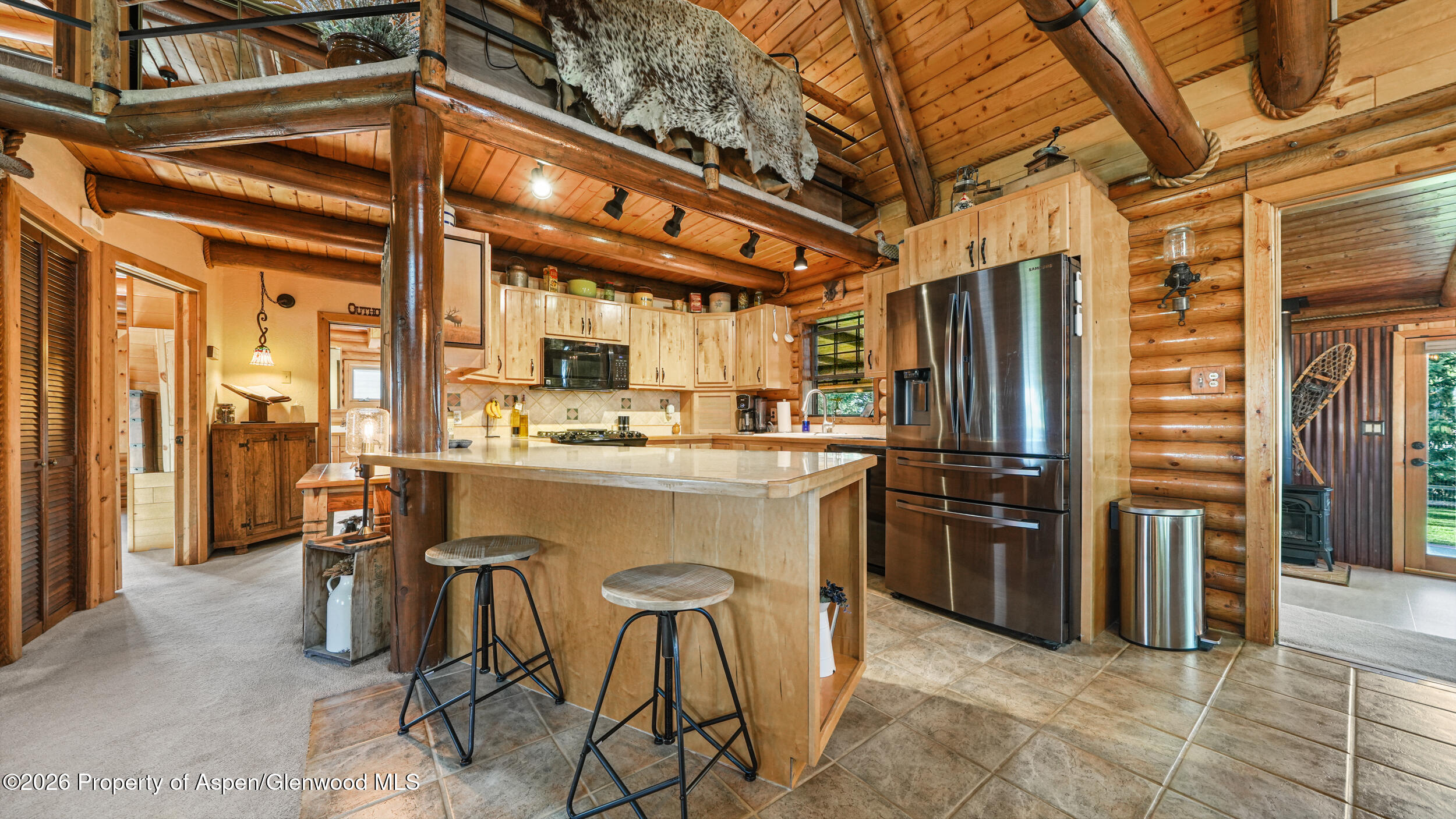 1355 N Road Loma, CO 81524 - Photo 19 of 51 a kitchen with stainless steel appliances kitchen island granite countertop a refrigerator and cabinets