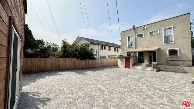 a view of a house with a yard and sitting area