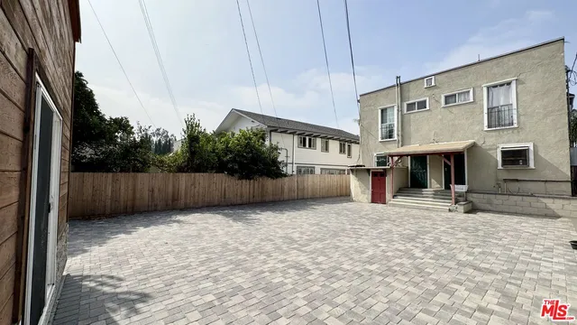 a view of a house with a yard and sitting area