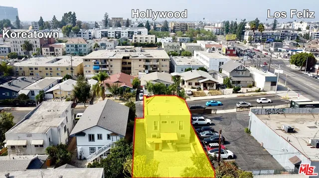 an aerial view of a house with table and chairs
