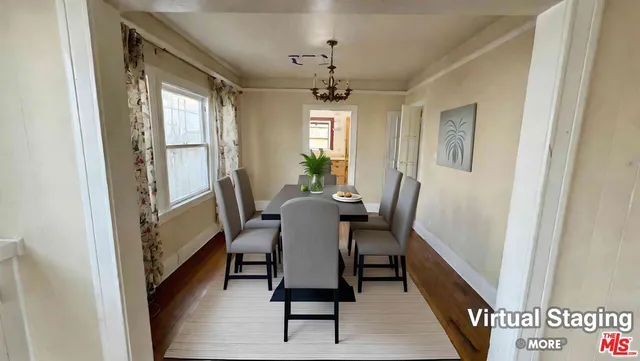 a view of a dining room with furniture and window