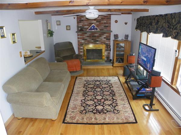 10 Blueberry Road, Unit R Derry, NH 03038 - Photo 8 of 15 a living room with furniture and a fireplace