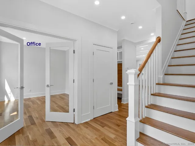 a view of an entryway with wooden floor