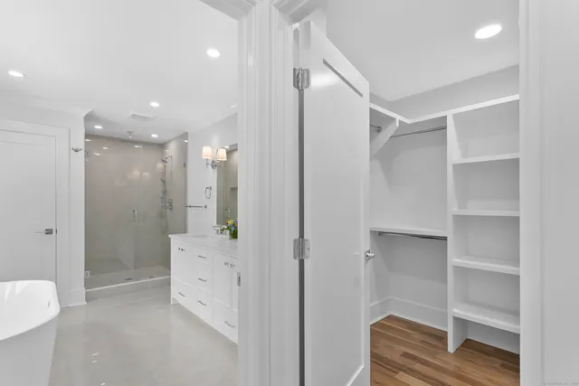 a bathroom with a double vanity sink mirror and window