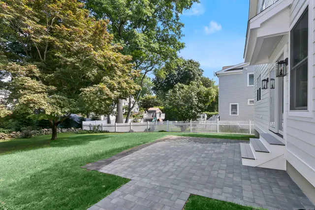 a view of backyard with outdoor seating and green space