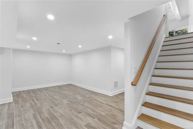 a bathroom with a double vanity sink mirror and shower