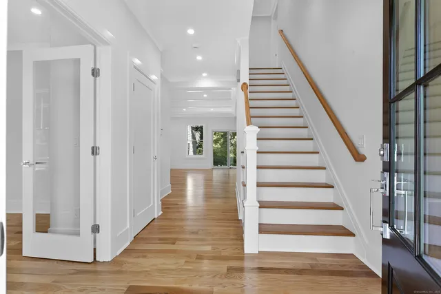 a view of entryway and hall with wooden floor