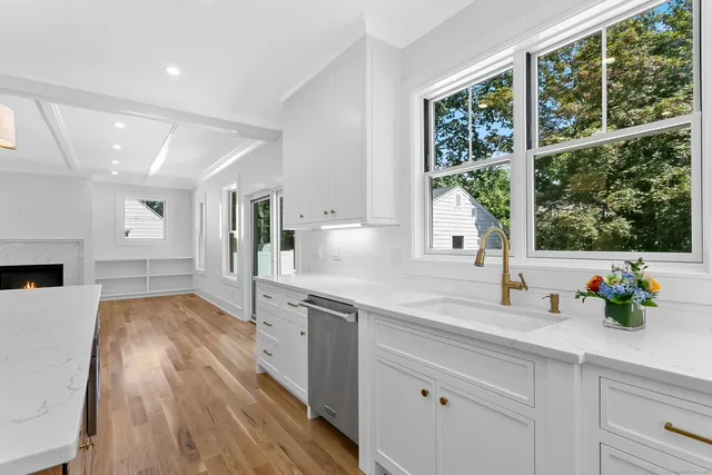 a kitchen with a sink and wooden floor