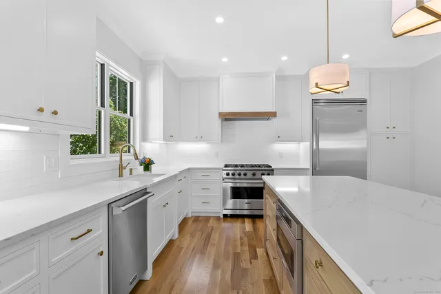 a kitchen with a stove a sink and a refrigerator