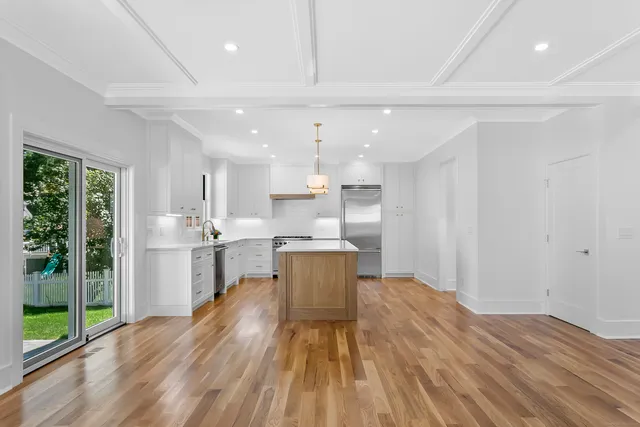 a kitchen with a sink and wooden floor