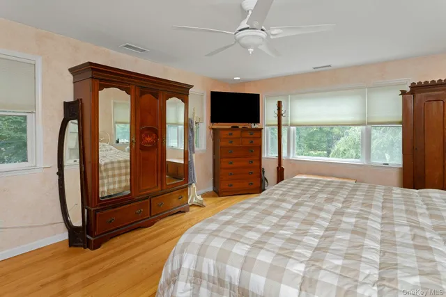 a bedroom with a large bed and a window