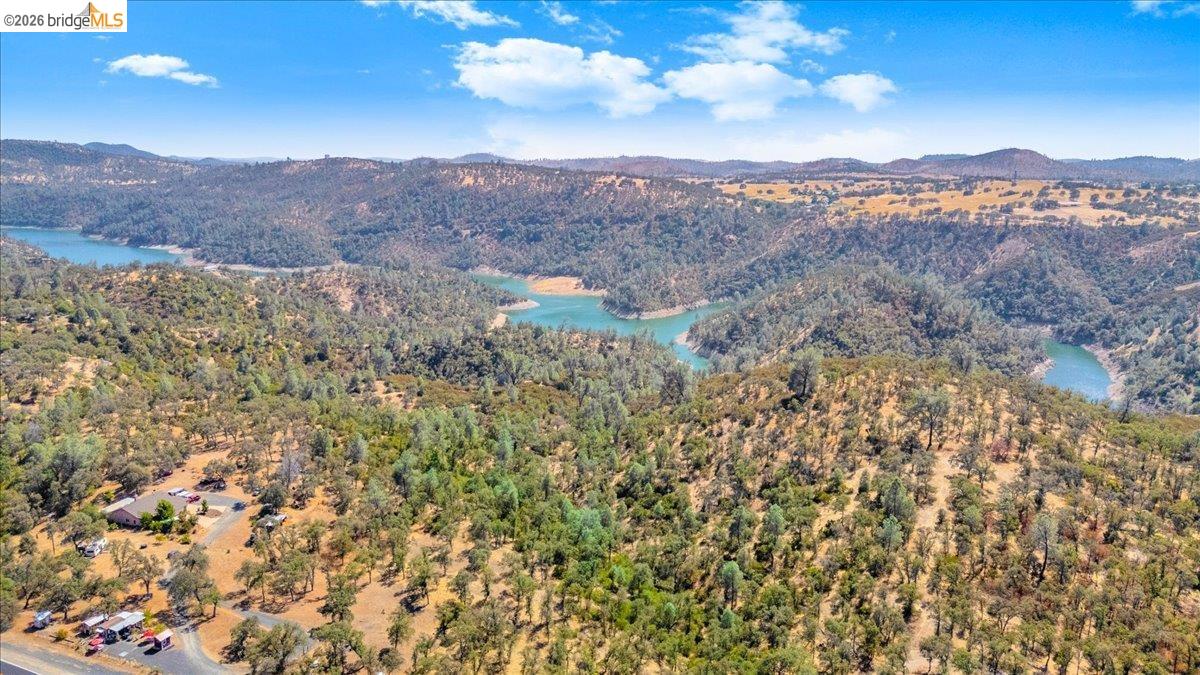 14450 Jacksonville Road Jamestown, CA 95327 - Photo 10 of 85 Expansive natural landscape with a prominent body of water, rolling hills, and abundant mature trees