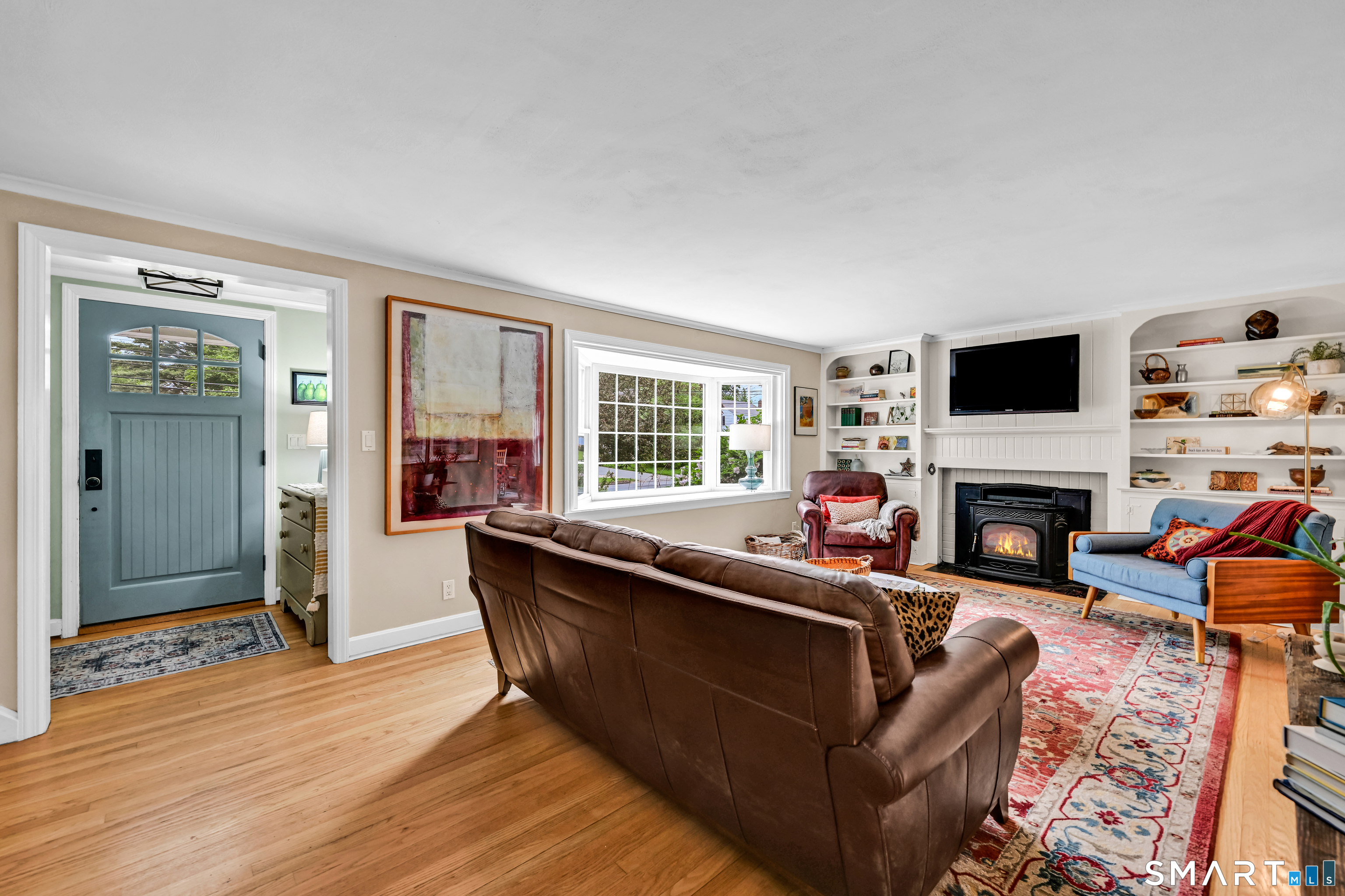 47 Spring Lane West Hartford, CT 06107 - Photo 3 of 38 a living room with furniture a fireplace and a flat screen tv