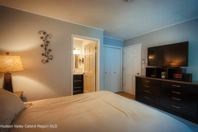 a bedroom with a bed and a flat screen tv