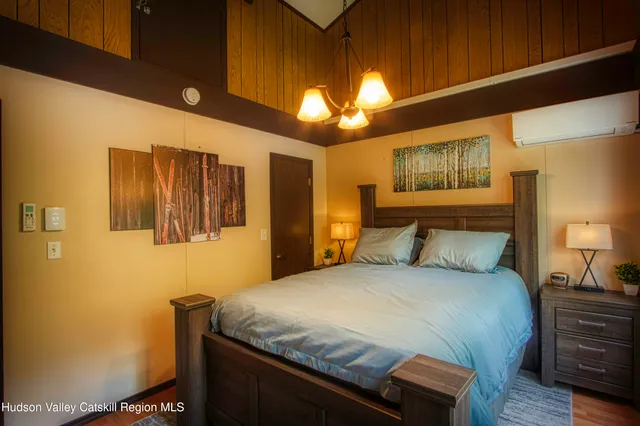 a bedroom with a bed and a chandelier