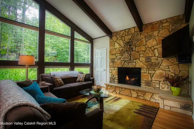 a living room with fireplace furniture and a flat screen tv