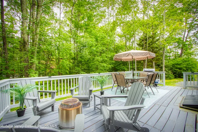 a view of a chair and table on the deck