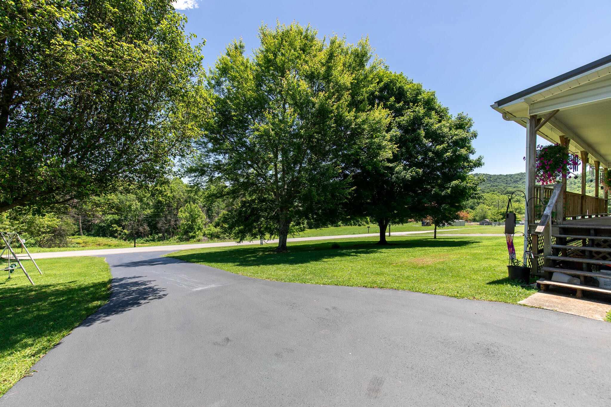 219 Corbin Lake Road Rutledge, TN 37861 - Photo 3 of 41 a view of a park with large trees and a small barn
