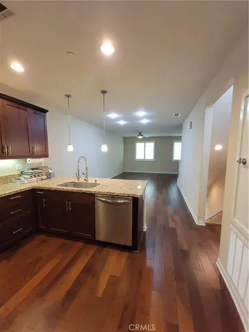 a large kitchen with wooden floors and wooden cabinets