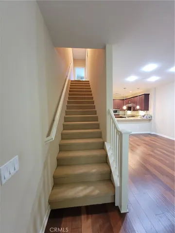 a view of a hallway with wooden floor and entryway