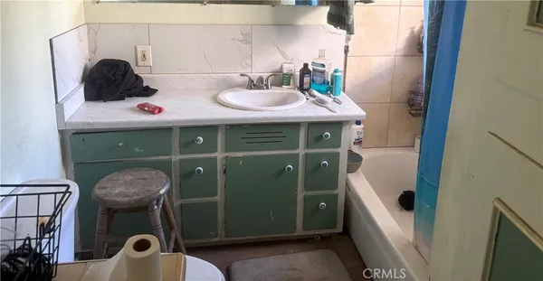 a bathroom with a sink toilet and a mirror