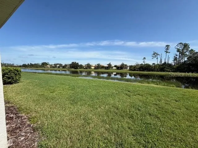 a view of a lake with houses in the back