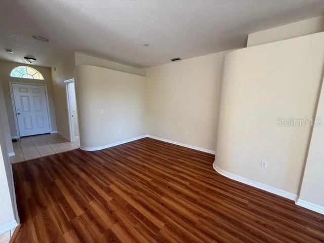 a view of wooden floor and closet in a hall