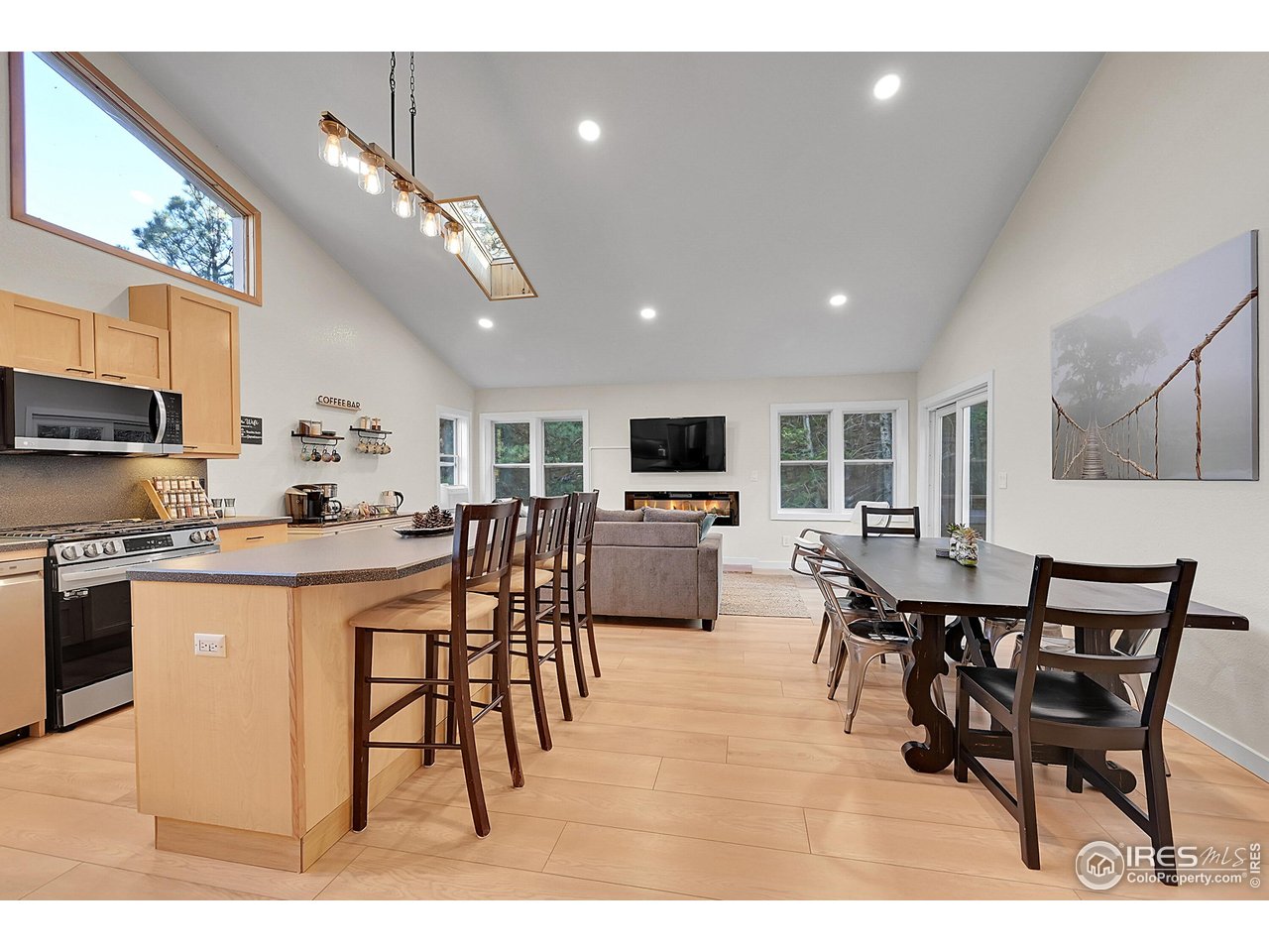 342 Brook Circle Boulder, CO 80302 - Photo 12 of 25 a kitchen with stainless steel appliances kitchen island granite countertop a dining table chairs and a refrigerator